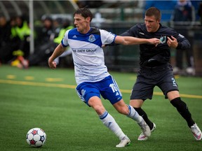 Daryl Fordyce  (16) of FC Edmonton scoots around Justin Davis (2) of the Minnesota United FC during North American Soccer League game action at Clarke Field on Sept. 6, 2015.  Fordyce scored on a free kick with a minute left to play to give Edmonton a 1-1 draw with Minnesota.