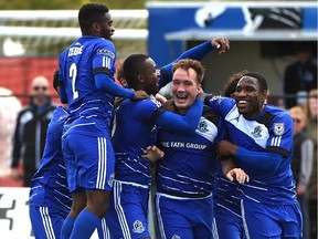 FC Edmonton players celebrate captain Albert Watson's (centre) goal against the Tampa Bay Rowdies at Clarke Stadium in Edmonton on Sept. 13, 2015.