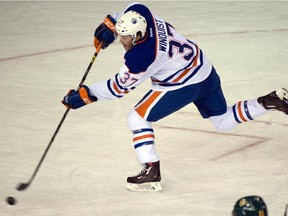 Josh Winquist shoots on goalie Luke Siemens (30) in the annual matchup between the Oilers rookies and the Canadian Interuniversity Sport (CIS) champions, the University of Alberta Golden Bears in Edmonton, Sept. 16, 2015.