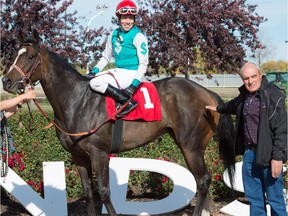 Shannon Beauregard won the Alberta Oaks on Blameitontheknight at the Alberta Fall Classic on Sept. 19, 2015. Trainer Dale Saunders is on the right.