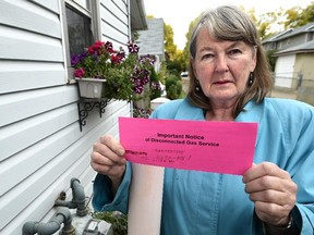 Joanne McNeal has had her gas cut off because she was unable to pay her Direct Energy bills in full and has no hot water or heat now, in Edmonton, Sept. 20, 2015.