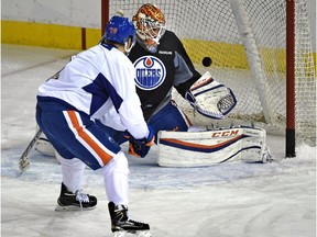 Edmonton Oilers goalie Cam Talbot stops a shot by Iiro Pakarinen at practice at Rexall Place in Edmonton, Sept. 28, 2015.