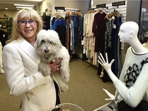 Ljiljana Kujundzic-Tesevic, owner of Liliana's Boutique in LeMarchand Mansion, getting ready for her grand opening, a fundraiser for E4C school lunch program in Edmonton. She is shown with her dog Dior.