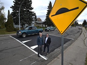 Coun. Michael Oshry, chair of the city's transportation committee, and Darrell Mullen, transportation services supervisor, stand on a speed bump along 94B Avenue in Ottewell for the launch of a new traffic shortcutting pilot project for four Edmonton neighbourhoods.