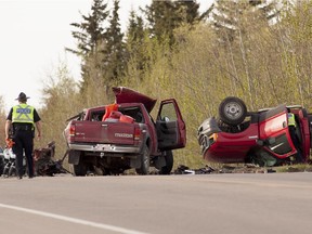 Edmonton police officers inspect the scene of a fatal crash on 50th Street near 41st Avenue on May 21, 2014.
