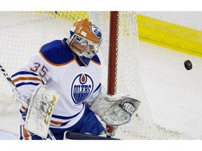 Edmonton Oilers goalie Eetu Laurikainen (35) makes the save against the University of Alberta Golden Bears during second period exhibition hockey action in Edmonton on Wednesday Sept. 16, 2015.