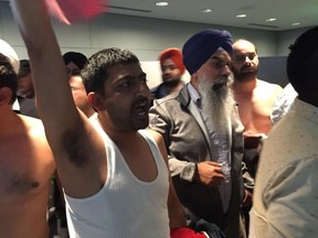 Some taxi drivers attending a city council meeting Tuesday took off their shirts and yelled "shame, shame," during a heated meeting about the ride-sharing service Uber.