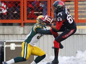 Calgary Stampeders' Eric Rogers, right, makes a touchdown catch beside Edmonton Eskimos' Otha Foster during 2nd quarter CFL Western Final action in Calgary  on Sunday Nov. 23, 2014.