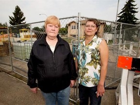 Irene Blain and Laurie Thiesen stand in front of a broken sewer pipe in West Jasper Place that has strong odours coming from it on Aug. 25, 2015.