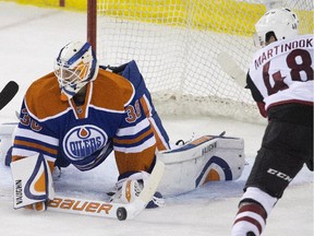 Arizona Coyotes' Jordan Martinook, right, is stopped by Edmonton Oilers' goalie Ben Scrivens during second period NHL pre-season action at Rexall Place on Tuesday, Sept. 29, 2015.