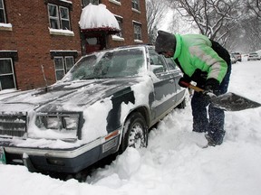 A small patch of Mars is now named after Winnipeg, likely in a nod to the Manitoba capital's claim to fame as sometimes being as cold as the Red Planet. This file photo from Nov. 15, 2005 shows a Winnipeg truck driver digging his car out of the snow.