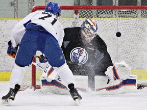 Edmonton Oilers' Kyle Platzer scores on goalie Ben Scrivens during training camp in Leduc, Alta., on Friday, Sept. 18, 2015.