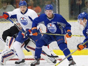 Edmonton Oilers Leon Draisaitl, left, and Connor McDavid take part in a drill during training camp in Leduc, Alta., on Friday September 18, 2015.