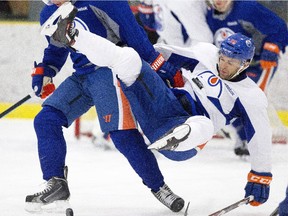 Edmonton Oilers' Matt Ford is knocked down during a drill at training camp in Leduc, Alta., on Friday, Sept. 18, 2015.