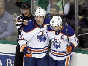 Edmonton Oilers' Taylor Hall (4) celebrates a goal with teammate Jordan Eberle in an NHL game against the Dallas Stars on Nov. 25, 2014, in Dallas.