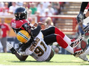 Defensive end Marcus Howard, shown tackling Calgary quarterback Henry Burris in September 2011, is one of the few Edmonton Eskimos players who have ever won a game over the Stampeders.