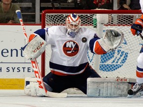 Anders Nilsson #45 of the New York Islanders makes the third period save against the New Jersey Devils at the Prudential Center on April 11, 2014 in Newark, New Jersey.