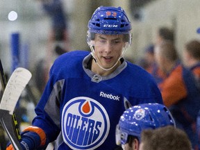 Ryan Nugent-Hopkins talks to players on the bench during the Edmonton Oilers' training camp at the Leduc Recreation Centre on Sept. 20, 2015.