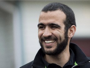 Omar Khadr smiles as he speaks to the media outside his new home, also his lawyer's home, after being granted bail in Edmonton on May 7, 2015.