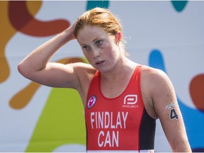 Canada's Paula Findlay reacts after crossing the finish line to place ninth in the Women's Triathlon at the Pan Am Games in Toronto on July 11, 2015.