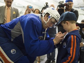 Caleb Syvenky of Kelowna, B.C., gets an autograph from Connor McDavid after practice at the South Okanagan Events Centre in Penticton.