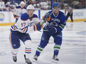 Jake Virtanen of the Vancouver Canucks shadows Connor McDavid  of the Edmonton Oilers during a Young Stars Classic game at the South Okanagan Events Centre in Penticton, B.C., on Sept. 11, 2015.