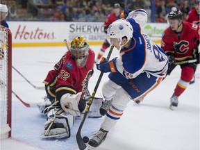 Caleb Jones of the Edmonton Oiler prospects, is denied at close range by Mason McDonald of the Calgary Flames prospects at the South Okanagan Events Centre in Penticton, B.C. on Sept. 12, 2015.