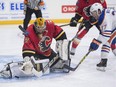 Josh Winquist of the Edmonton Oiler prospects, is stopped by Mason McDonald of the Calgary Flames prospects at the South Okanagan Events Centre in Penticton.