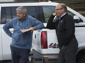 Edmonton Oilers head coach Todd McLellan and general manager Peter Chiarelli talk in the parking lot after an Oilers prospects practice at the South Okanagan Events Centre in Penticton, B.C., during the Young Stars Classic.