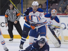 CALEB JONES of the Edmonton Oilers prospects takes down Nic Petan of the Winnipeg Jets at the South Okanagan Events Centre in Penticton.