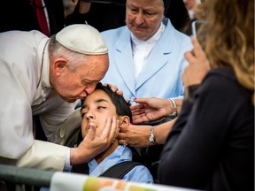 Pope Francis kisses and blesses Michael Keating, 10, of Elverson, Pa after arriving in Philadelphia Saturday, Sept. 26, 2015.
