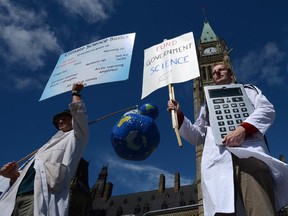 Scientists rally on Parliament Hill in Ottawa on Sept. 16, 2013 as Canadian scientists and their supporters hold demonstrations across the country, calling on the federal government to stop cutting scientific research and muzzling its scientists.