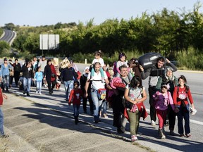 Syrian refugees and migrants walk along the highway on September 15, 2015, on their way to the border between Turkey and Greece in the northwestern Turkish city of Edirne. Over half a million migrants have crossed the European Union's border so far this year, up from 280,000 in 2014, the bloc's Frontex border agency said on September 15, 2015 -- but warned some people may have been counted twice.