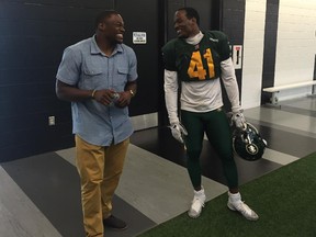 Free-agent linebacker Henoc Muamba, left, catches up with his former Winnipeg Blue Bombers teammate, Odell Willis, at an Edmonton Eskimos practice on Sept. 16, 2015.