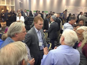 Andrew Leach, University of Alberta energy expert, chats with people at an open house on climate change  at the Chateau Louis Conference Centre on Wednesday, Sept. 2, 2015.