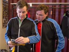 Brent, left, and Sean Sweeney look at a clue at the Ottewell Curling Club during the Edmonton leg of the Amazing Race Canada.