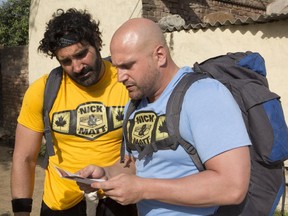 Wrestlers Nick Foti, left, and Matt Giunta read a clue on Amazing Race Canada.