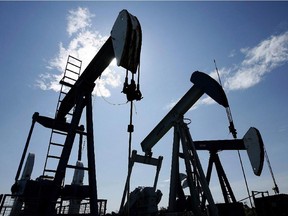 Pumpjacks at work pumping crude oil near Halkirk, Alta., June 20, 2007.