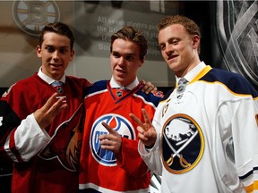 Connor McDavid, centre, taken first overall in the 2015 NHL entry draft by the Edmonton Oilers, stands with No. 2 pick Jack Eichel of the Buffalo Sabres, right, and No. 3 pick Dylan Strome of the Arizona Coyotes.
