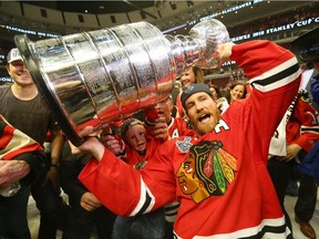 Duncan Keith celebrates Chicago's Stanley Cup victory on June 15, 2015. Keith will miss at least a month after knee surgery.