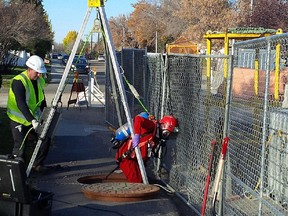 A City of Edmonton drainage employee enters the sewer system in West Jasper Place Oct. 8 near where residents have been complaining of sewer gas odours.