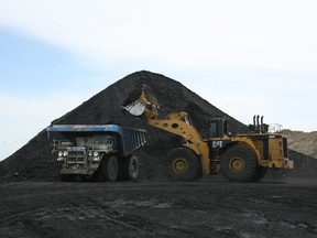 A truck is loaded with coal at the Luscar Genesee Mine in this June 1, 2006 file photo.