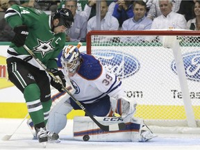 Edmonton Oilers goalie Anders Nilsson (39) defends the goal against Dallas Stars left wing Jamie Benn (14) during the first period on Tuesday, Oct. 13, 2015, in Dallas.