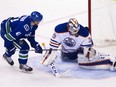 Edmonton Oilers goaltender Anders Nilsson makes a save against Vancouver Canucks' Sven Baertschi (47) during NHL action in Vancouver on October 18, 2015. The Oilers won 2-1 in OT.