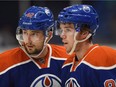 Edmonton Oilers' Anton Slepyshev, left and Connor McDavid speak during a break against the Minnesota Wild's during the first period of an NHL pre-season hockey game in Saskatoon, Sask., on Sept. 26, 2015.