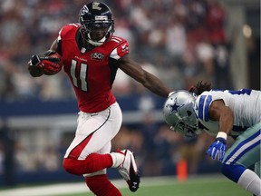 Wide receiver  Julio Jones of the Atlanta Falcons runs for a touchdown past  J.J. Wilcox of the Dallas Cowboys on Sept. 27, 2015, in Arlington, Texas.