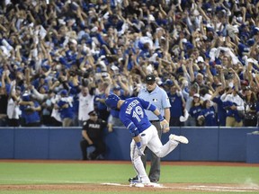 Toronto Blue Jays Jose Bautista rounds the bases on a three-run homer during seventh inning of Game 5 in American League Division Series baseball action in Toronto on Oct. 14, 2015.