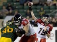 Calgary Stampeders Bo Levi Mitchell (19) makes the throw as Dan Federkeil (65) and Edmonton Eskimos Almondo Sewell (90) battle in front during the Sept. 12, 2015, contest between the two teams.