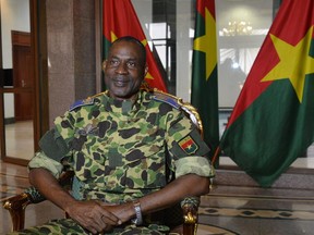 This Sept. 17, 2015 file photo shows Gen. Gilbert Diendere siting at the presidential palace in Ouagadougou after Burkina Faso's Presidential Guard declared a coup, a day after seizing the interim president and senior government members, as the country geared up for its first elections since the overthrow of longtime leader Blaise Compaore. Burkina Faso's military said on Oct. 16 that the general would be prosecuted on array of charges, including "crime against humanity."