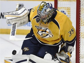 Pekka Rinne of the Nashville Predators tries to control a rolling puck against the Carolina Hurricanes during the second period at Bridgestone Arena on October 8, 2015 in Nashville, Tenn.